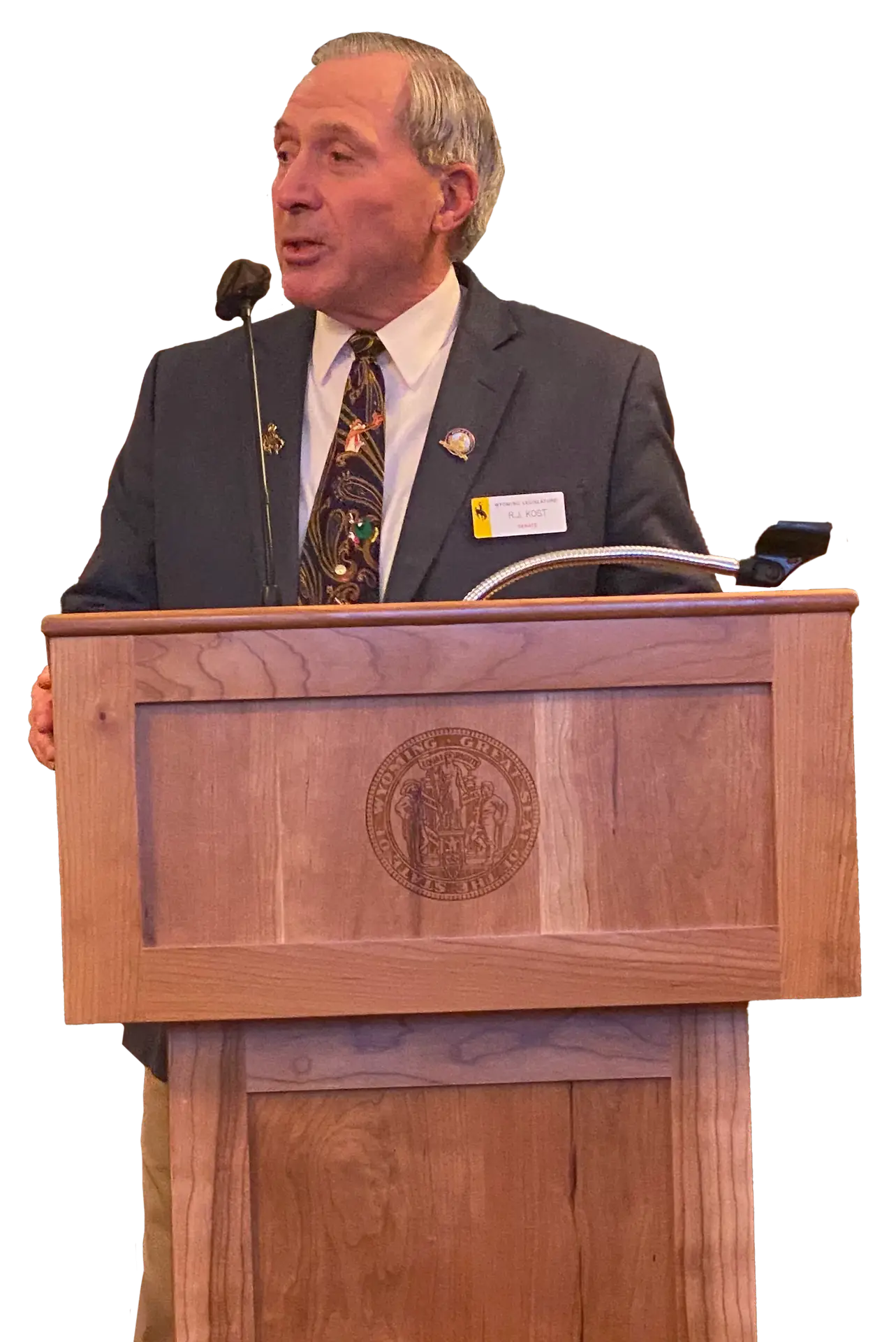 RJ Kost speaking at a podium, representing leadership and public service in Wyoming