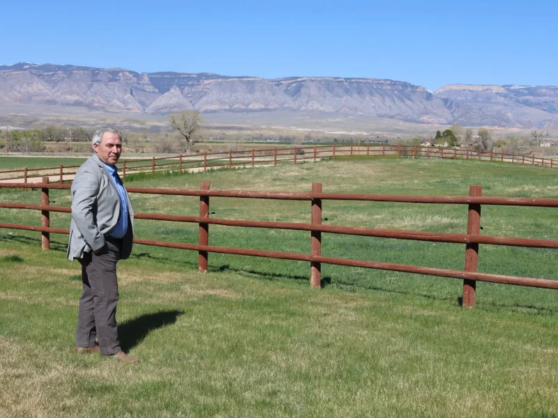 RJ Kost on his property with mountain views in the Big Horn Basin, reflecting Wyoming heritage and open land