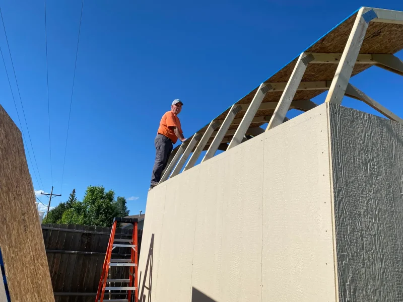 RJ Kost working on a building project, demonstrating hands-on skills and work ethic