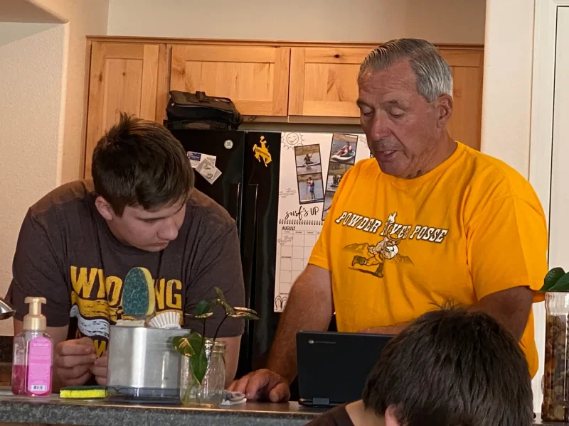 RJ Kost working at home with family, demonstrating leadership, mentorship, and family values