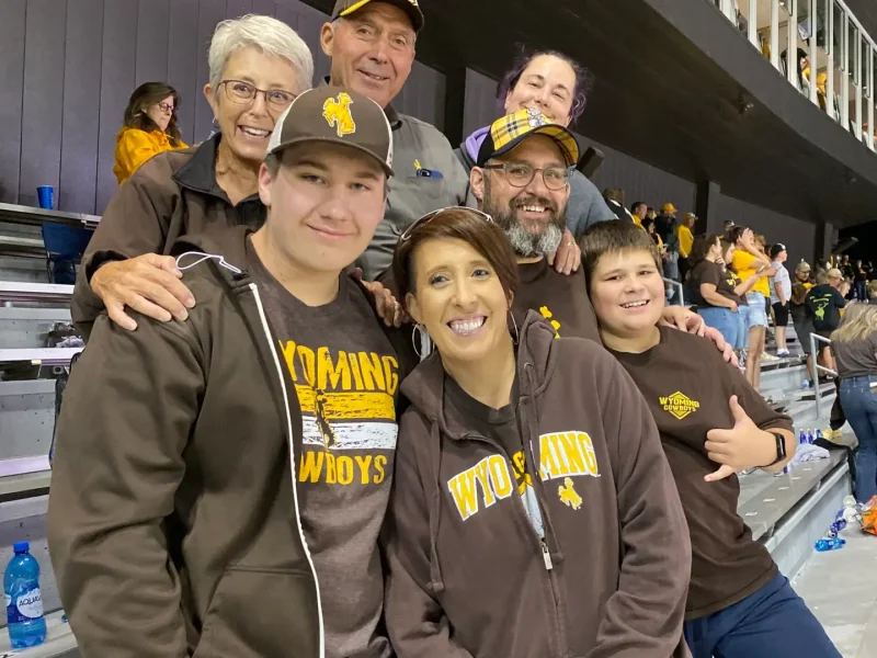 RJ Kost with family and supporters at a Wyoming Cowboys game, showing community pride