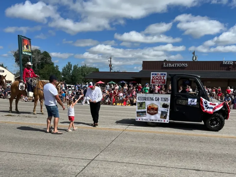 RJ Kost greeting families during a local parade, engaging with community members in Wyoming